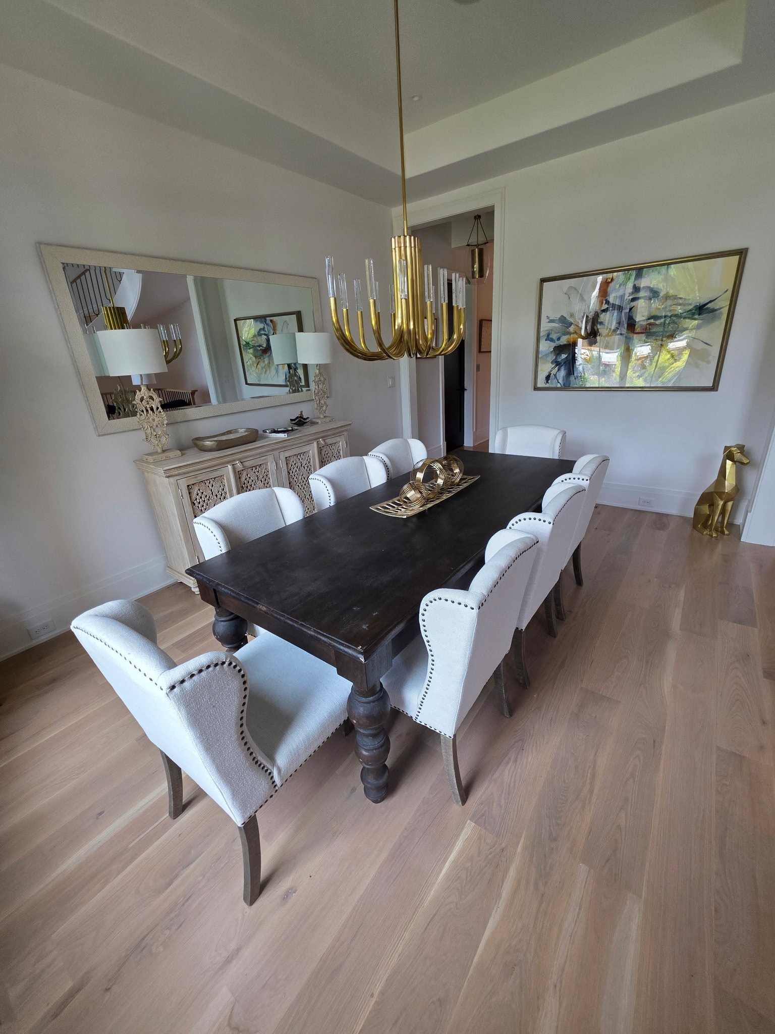 Two gray swivel chairs with cowhide rug and black wire coffee table
